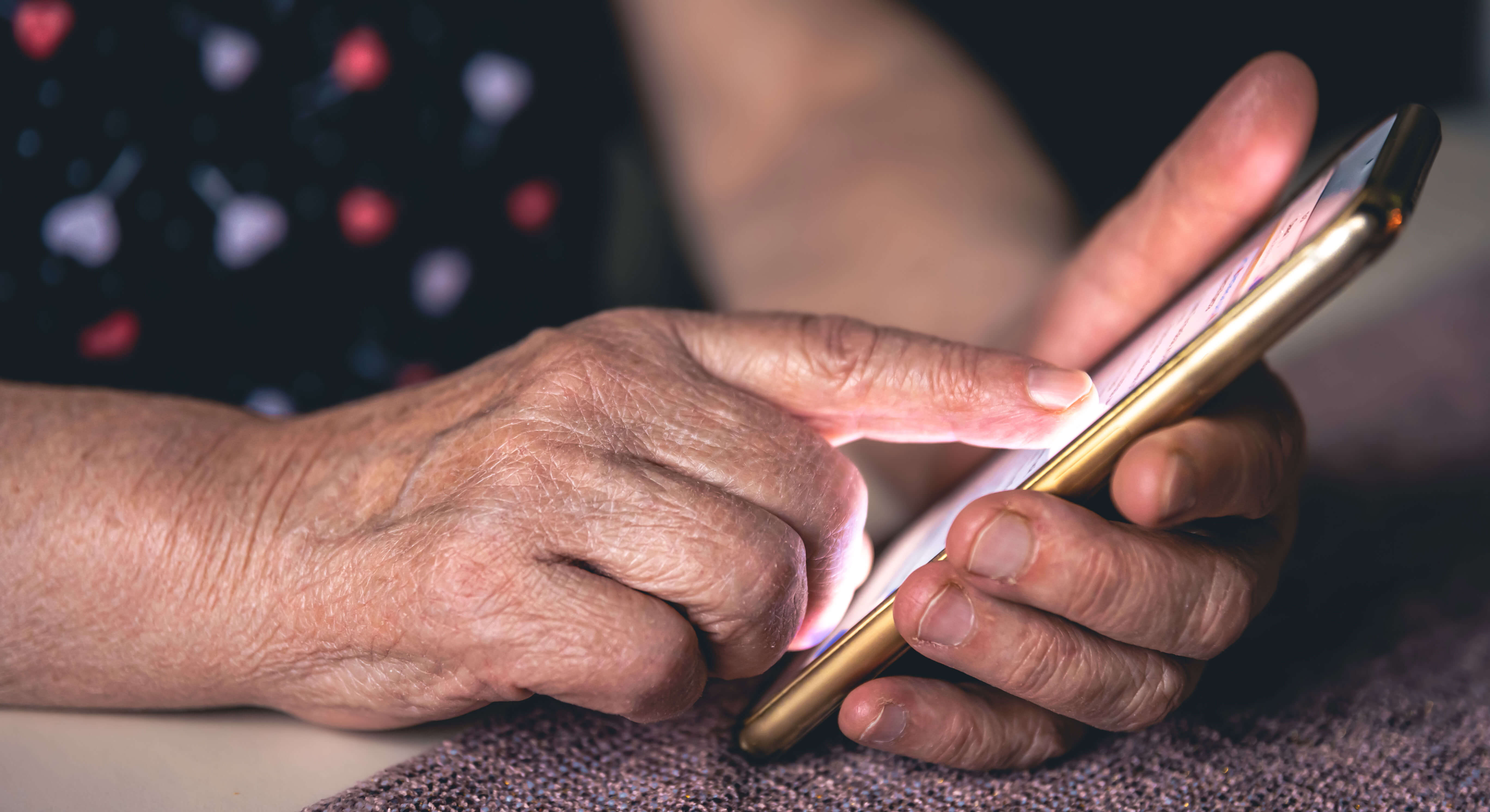 Hands of an elderly woman holding a mobile phone Hands of an elderly woman holding a mobile phone